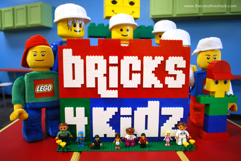 Lego figurines surrounding the words Bricks 4 Kidz formed by red, white, blue and green legos.
